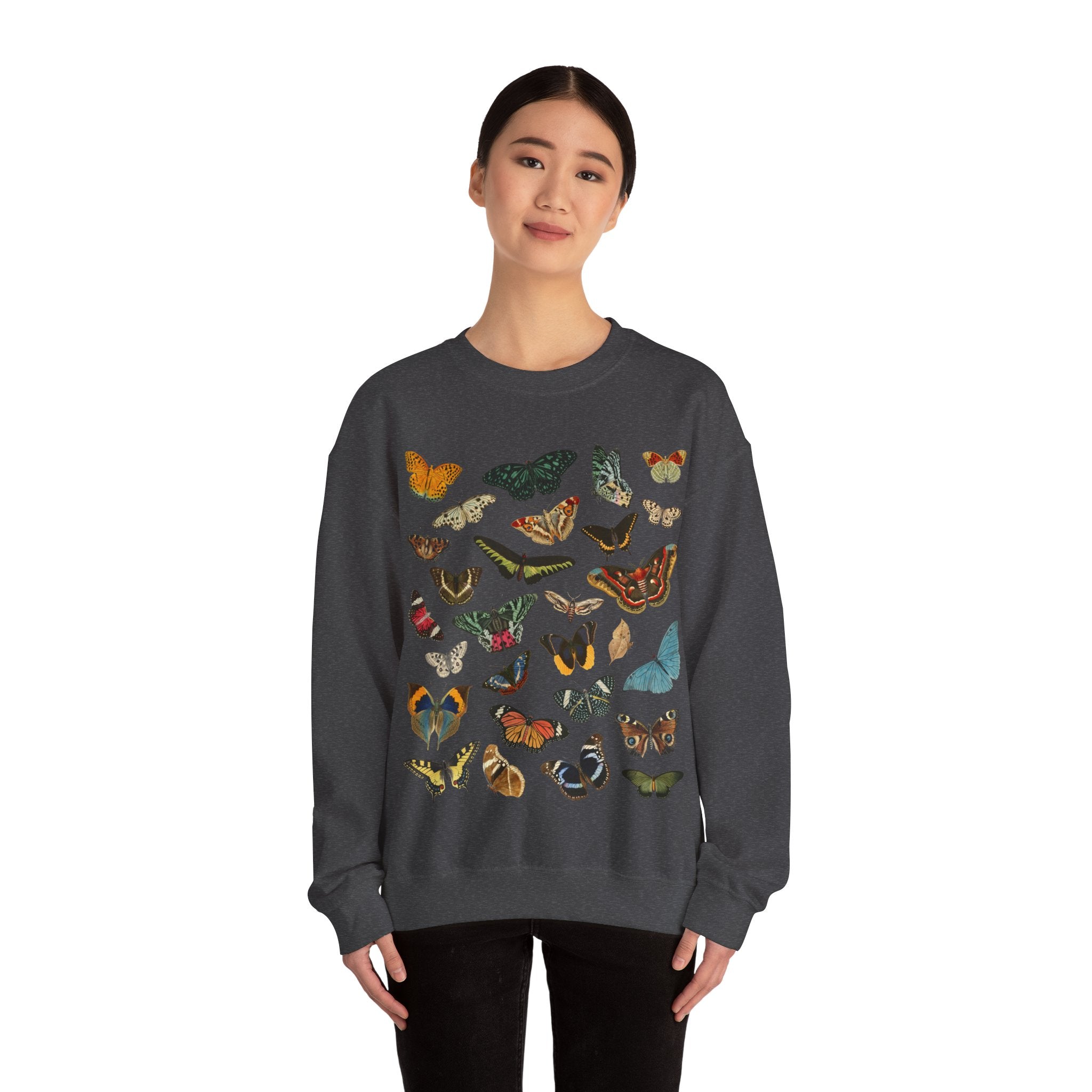 Person wearing a dark heather gray sweatshirt with colorful butterfly designs on a white background