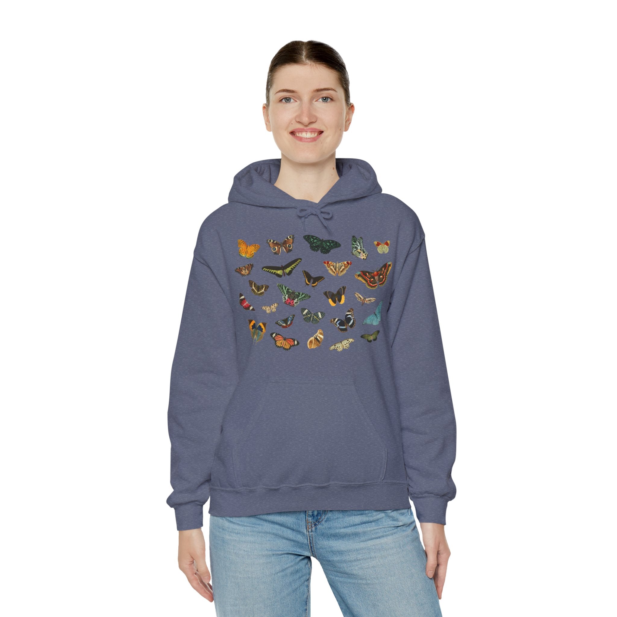 Person wearing a heather navy blue hoodie with butterfly designs on a white background
