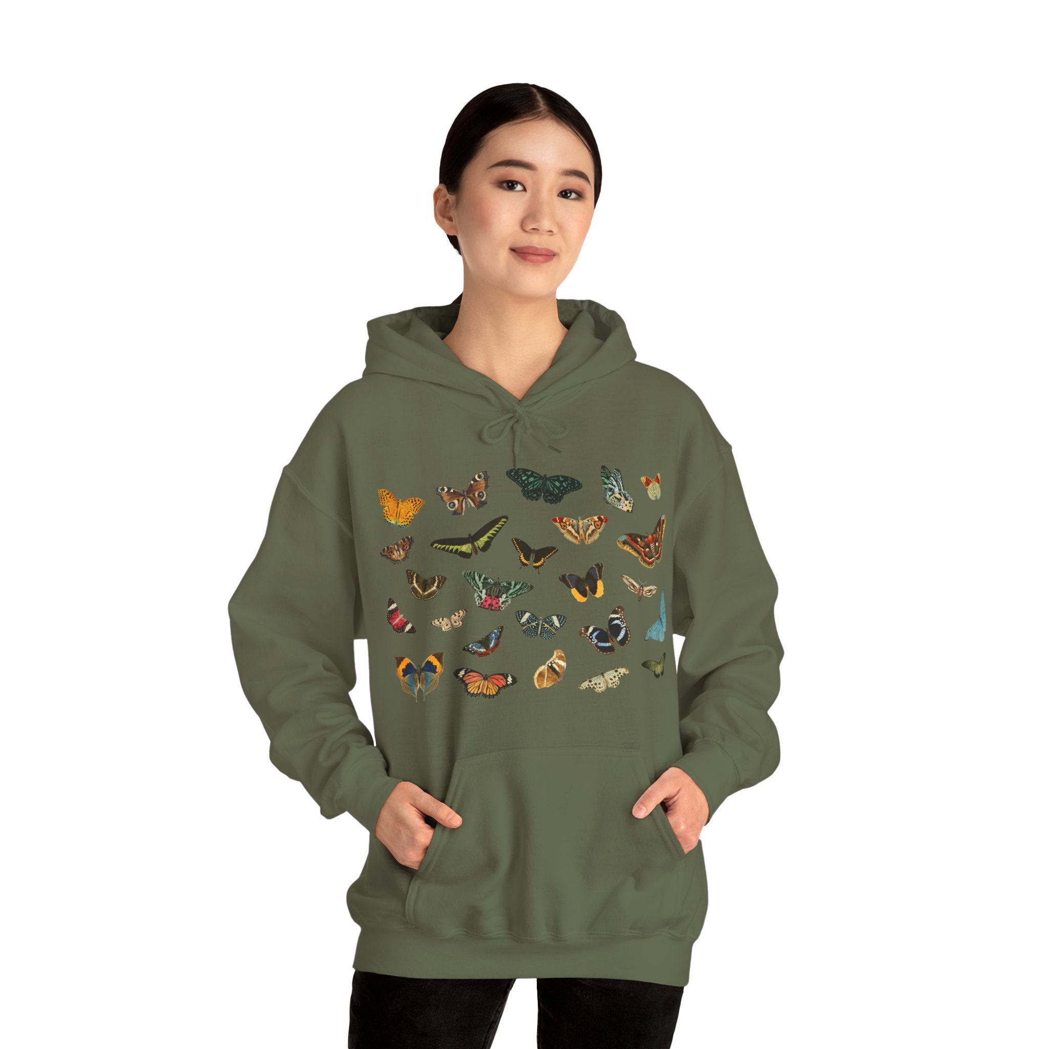 Person wearing a military green hoodie with butterfly designs on a white background