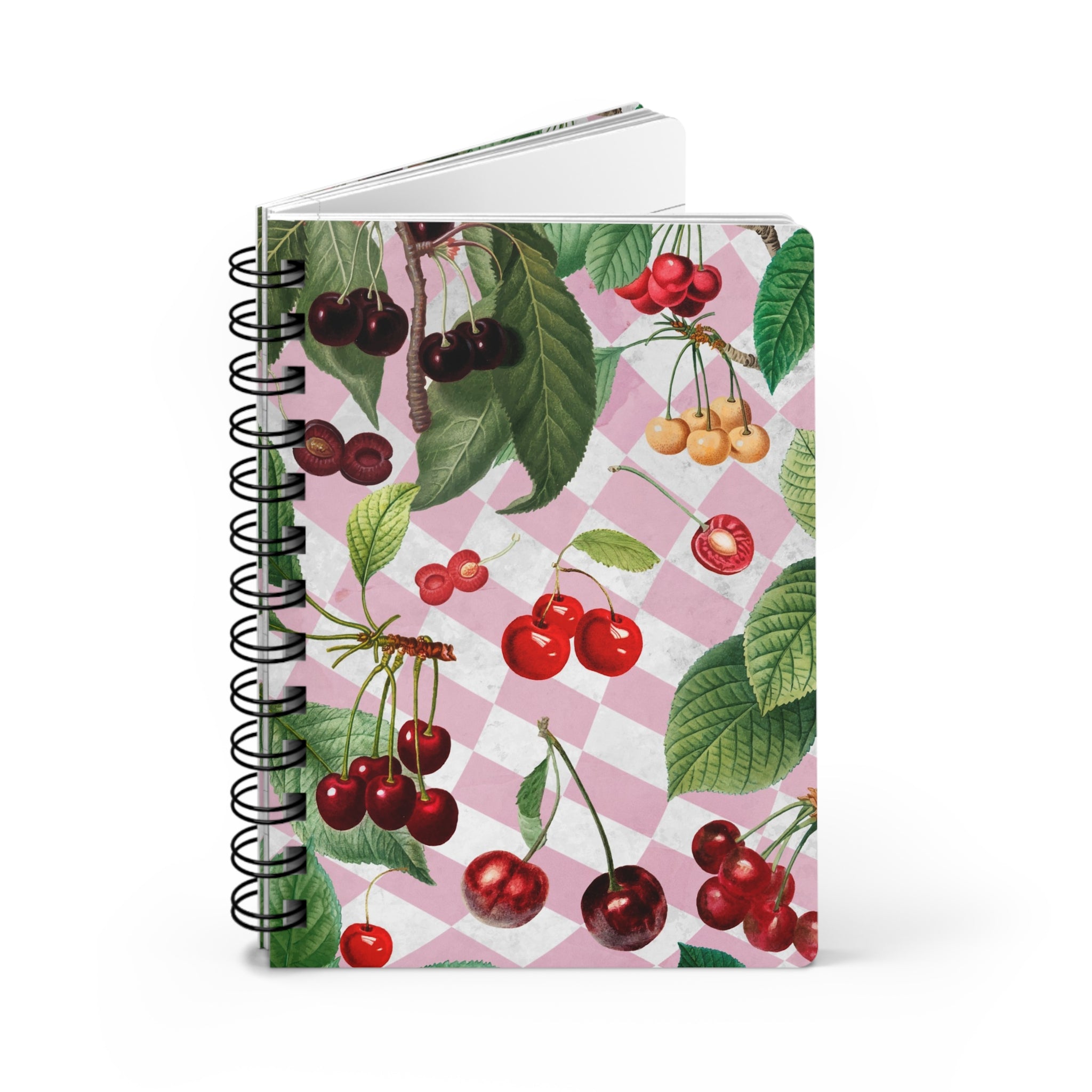 Notebook propped open with cherry design on a pink and white checkered background