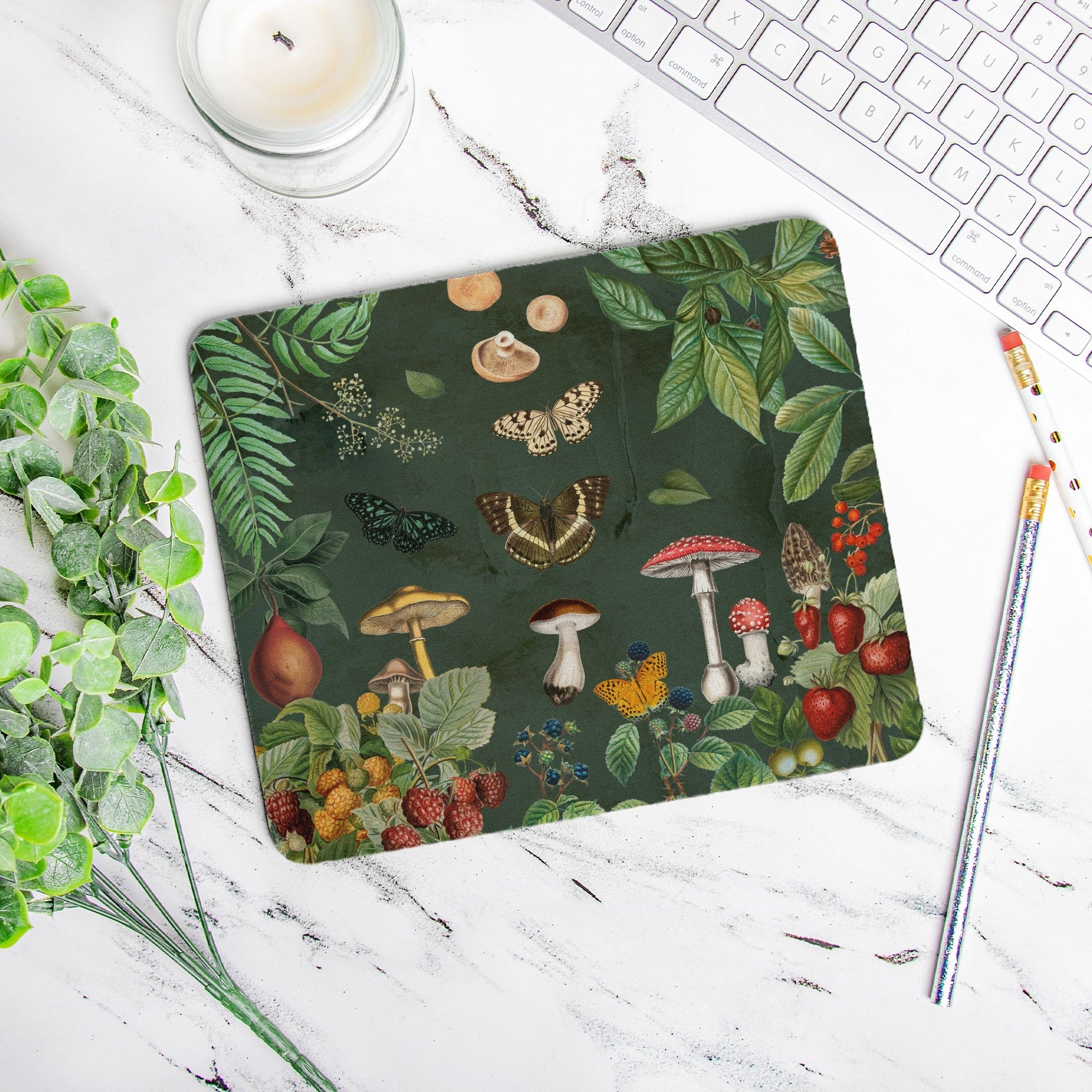 Cottagecore mouse pad Nature-themed mouse pad on a desk with a candle, keyboard, and pencils. Mushrooms, berries, butterflies and greenery.