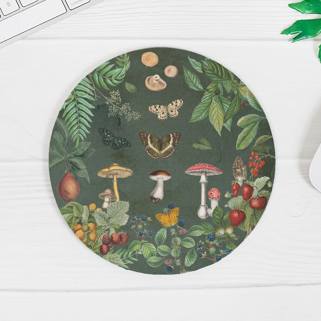 Round mouse pad with nature-themed design featuring mushrooms, leaves, and butterflies on a dark green background.