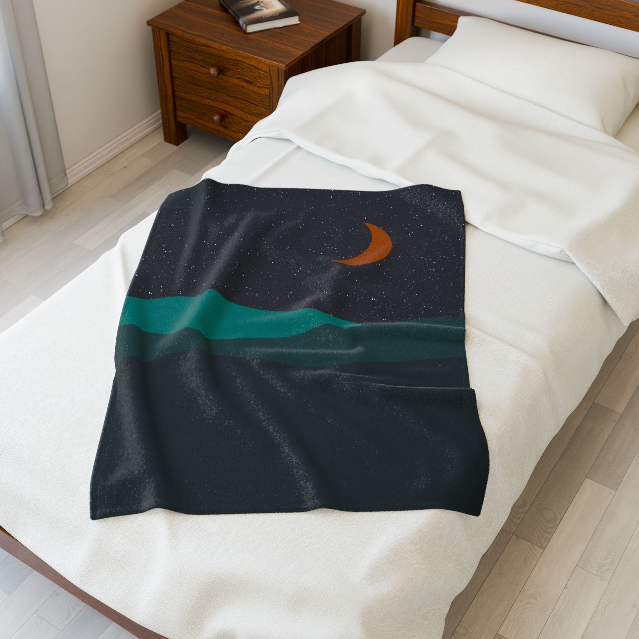 Blanket with a celestial design draped over a bed in a bedroom setting