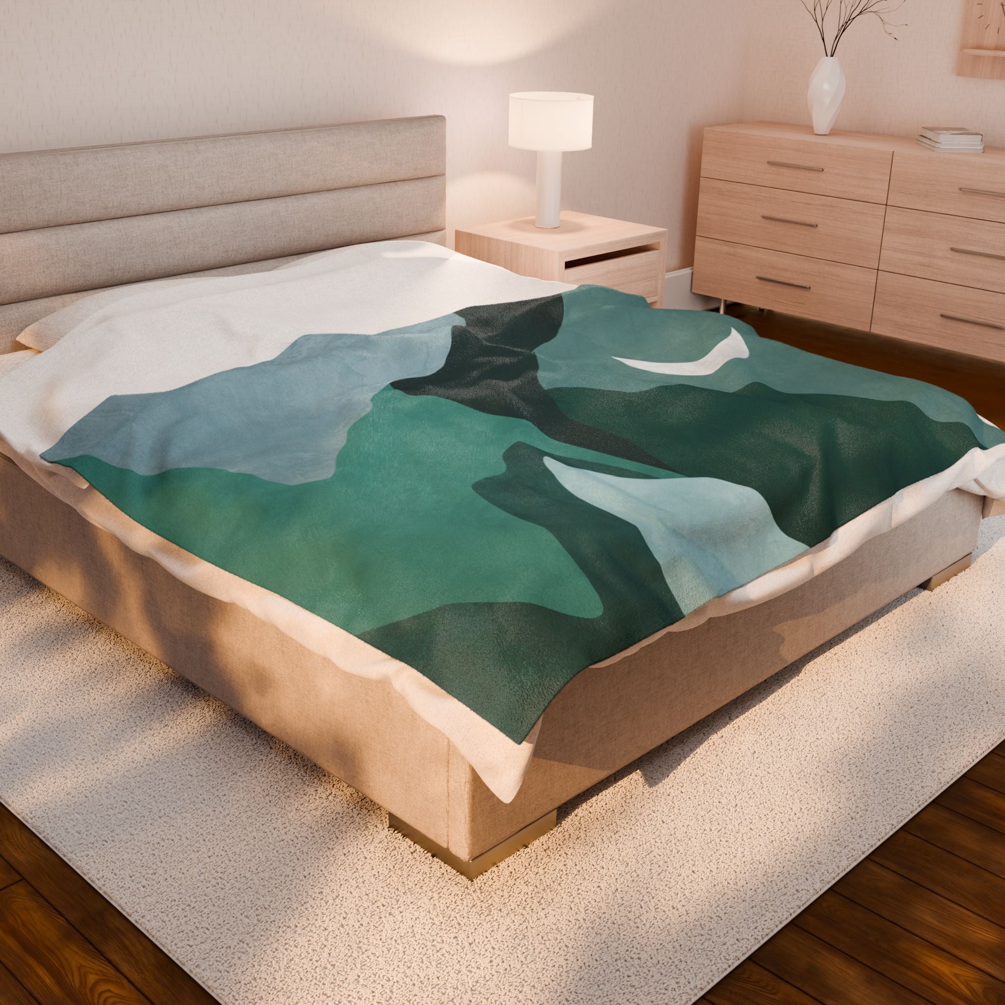 A mountain-themed blanket sideways on a queen bed in a bedroom setting. 60x80 inch velveteen plush blanket.