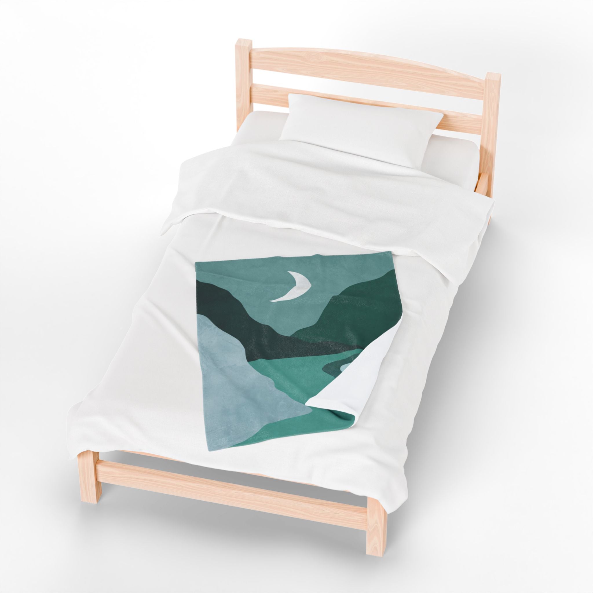 White duvet with with green abstract design lap blanket on it on a wooden bed frame against a white background