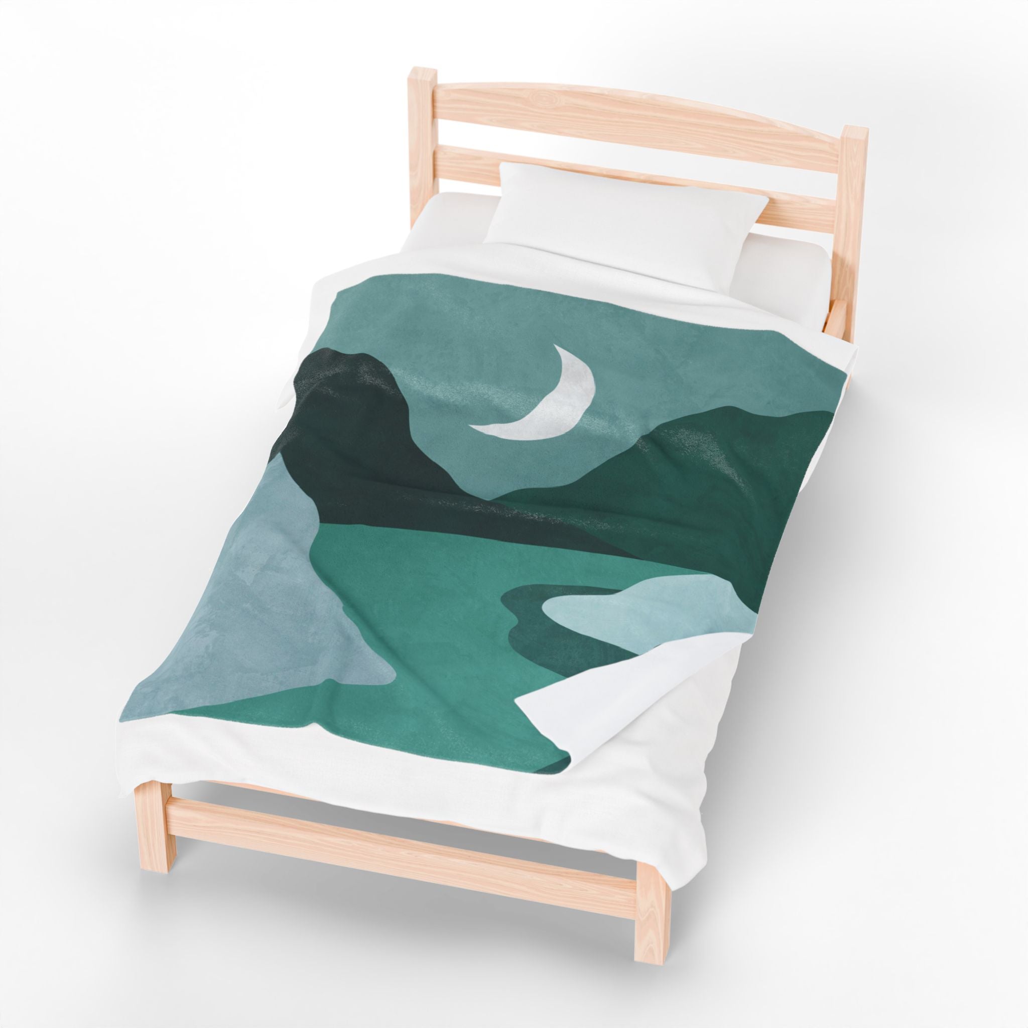 Bed with green and teal abstract mountain design duvet cover on a white background