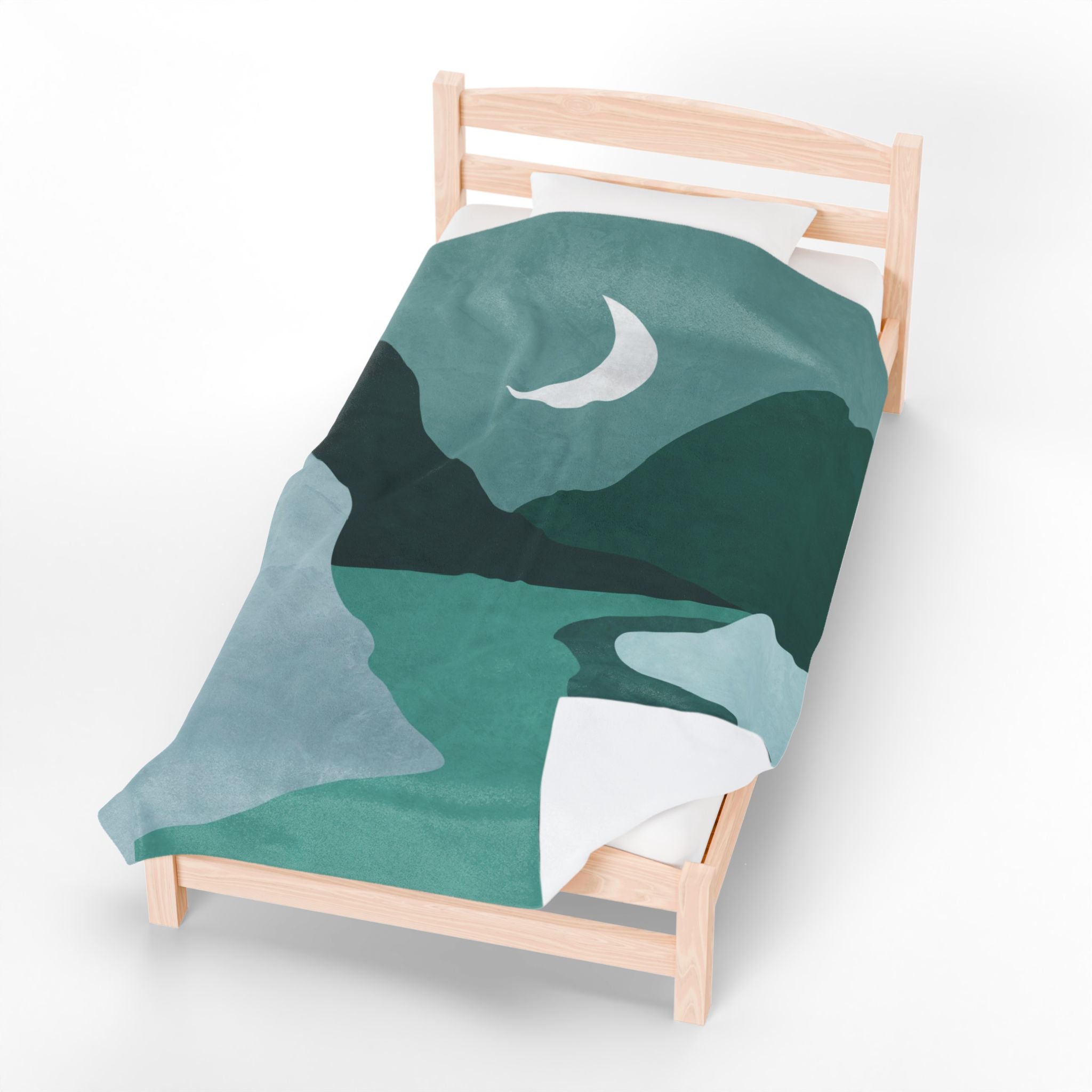 Green mountain and moon design blanket on a wooden bed with white bedding.