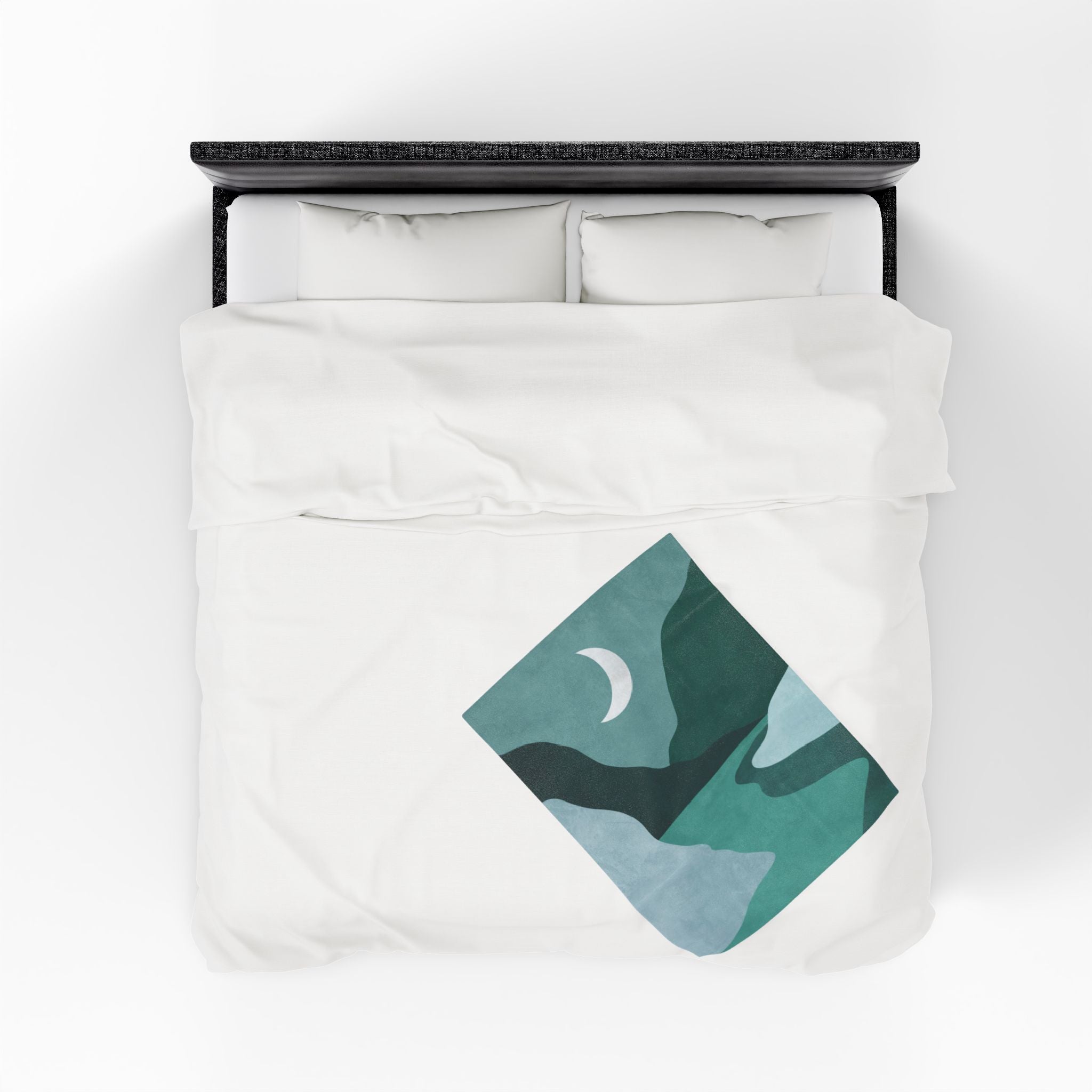 White bedding set with a green and blue geometric mountain design on a white background
