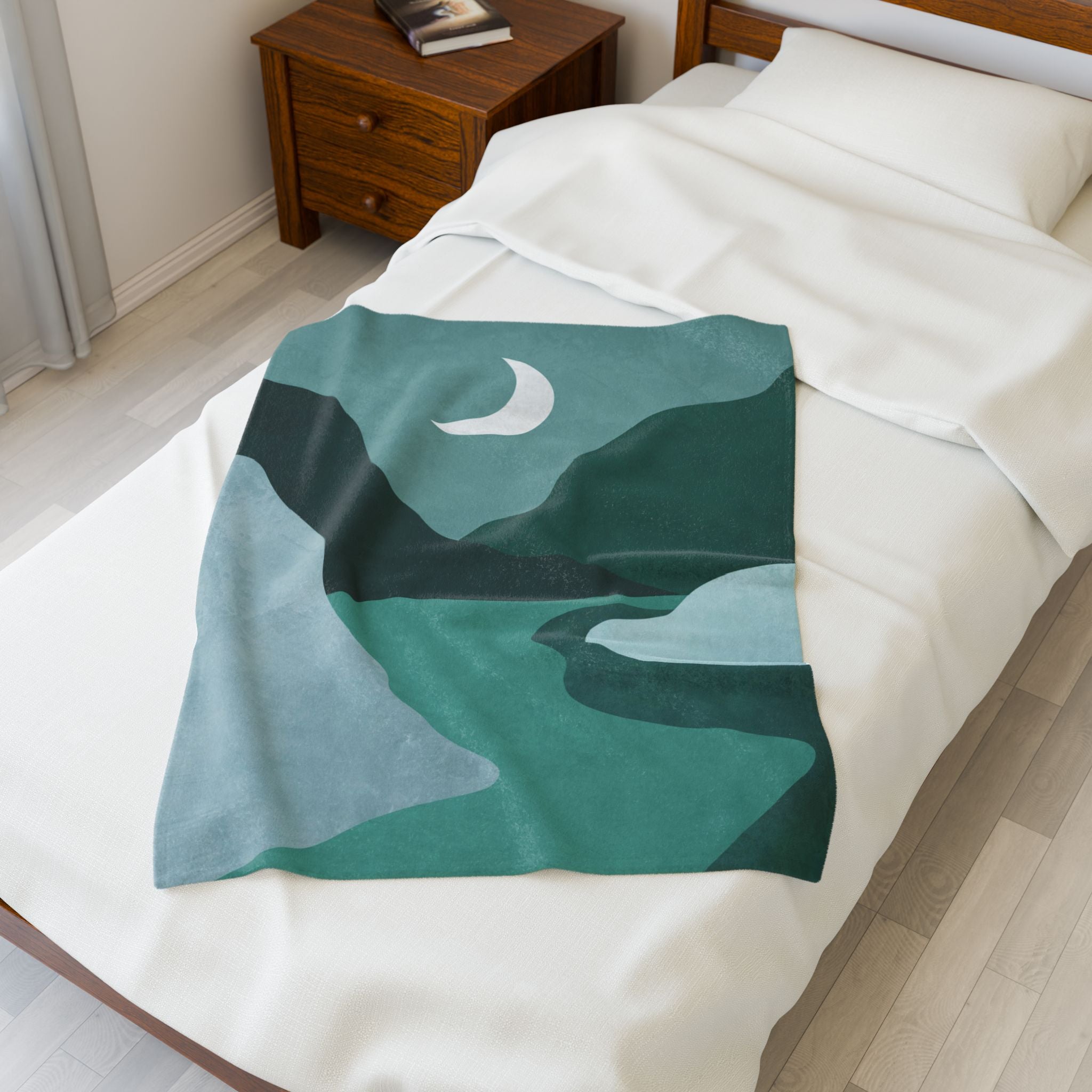 Blanket with a green landscape design draped over a twin bed in a bedroom.