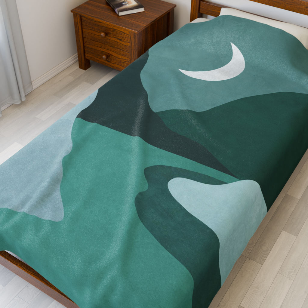 Teal and green abstract mountain stream patterned blanket on a twin bed in a bedroom. 60x80 inch velveteen plush blanket.