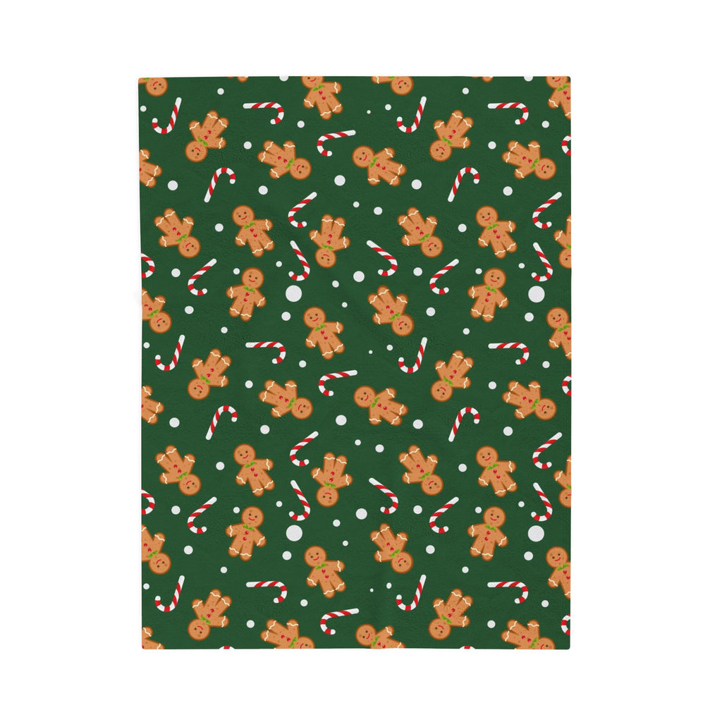 Pattern of gingerbread men, candy canes, and polka dots on a green background