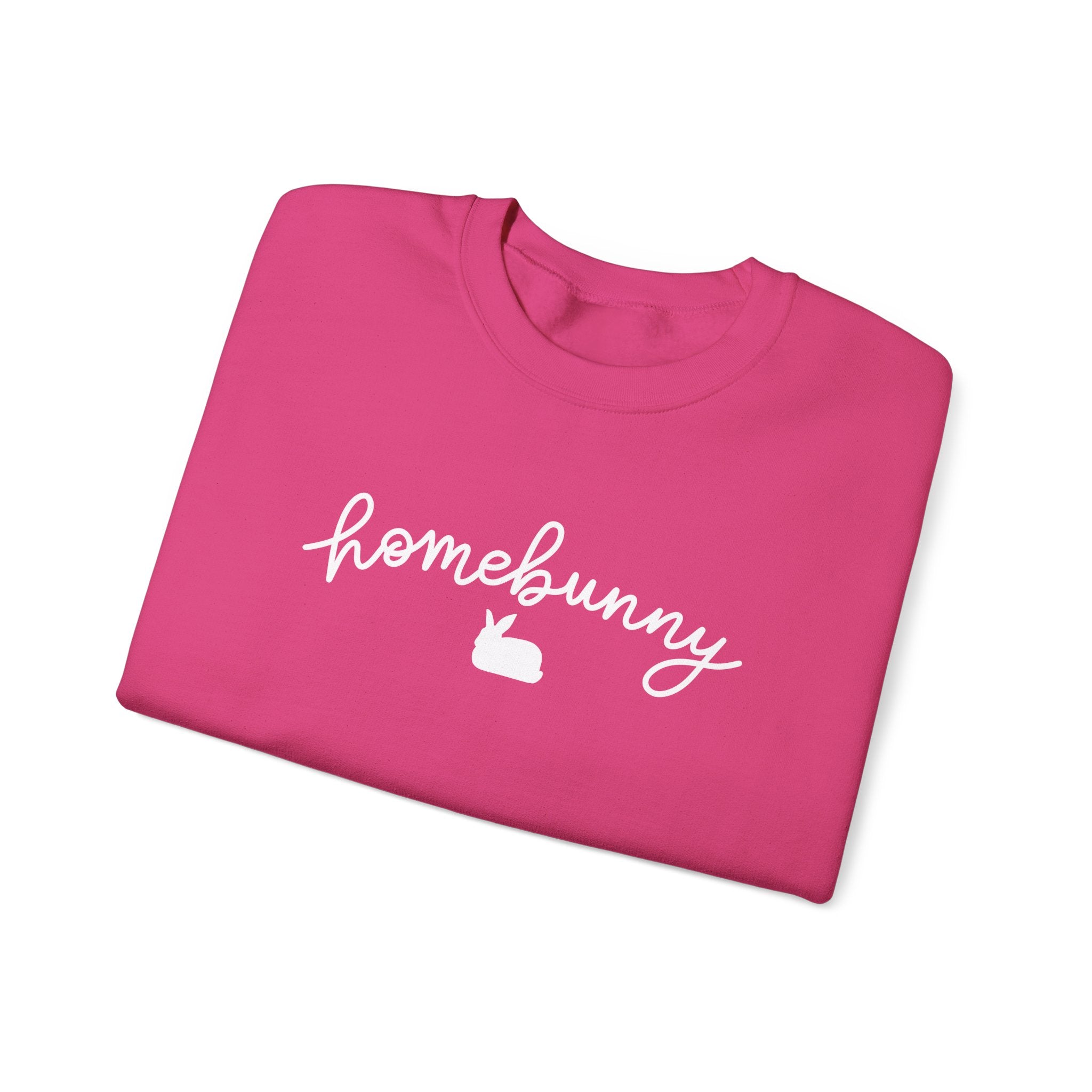 Folded heliconia pink sweatshirt with 'homebunny' text and rabbit icon on a white background