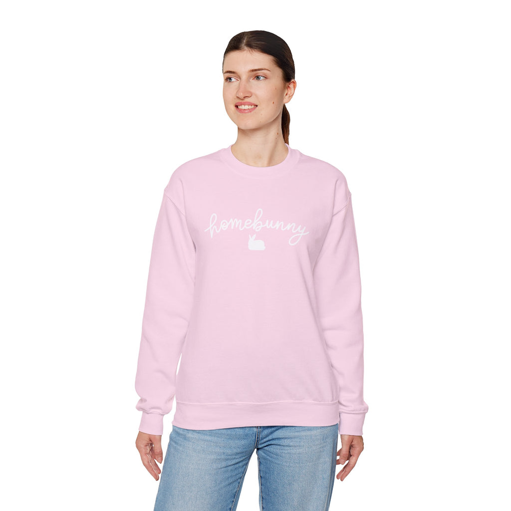 Person wearing a light pink sweatshirt with text on a white background