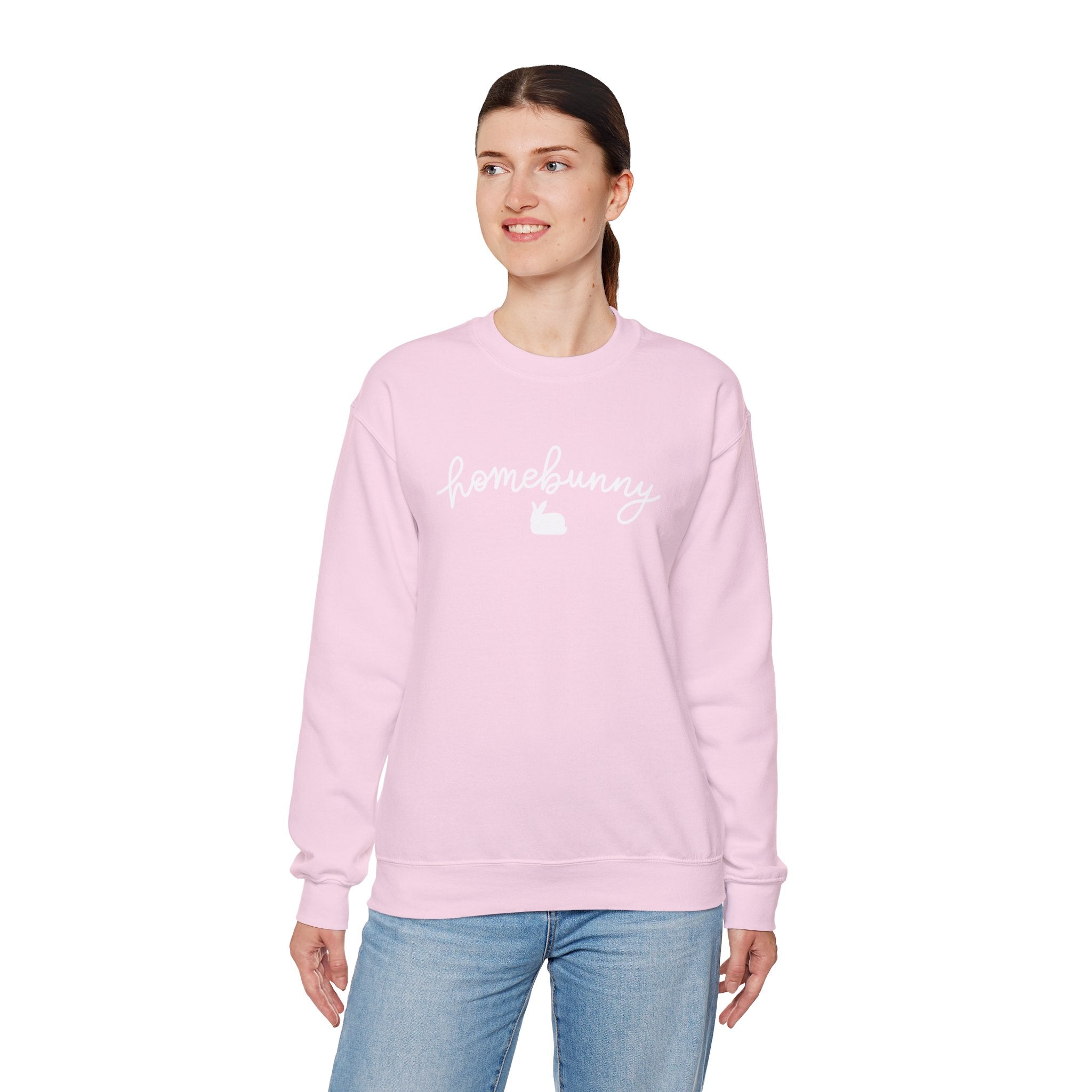 Person wearing a light pink sweatshirt with text on a white background