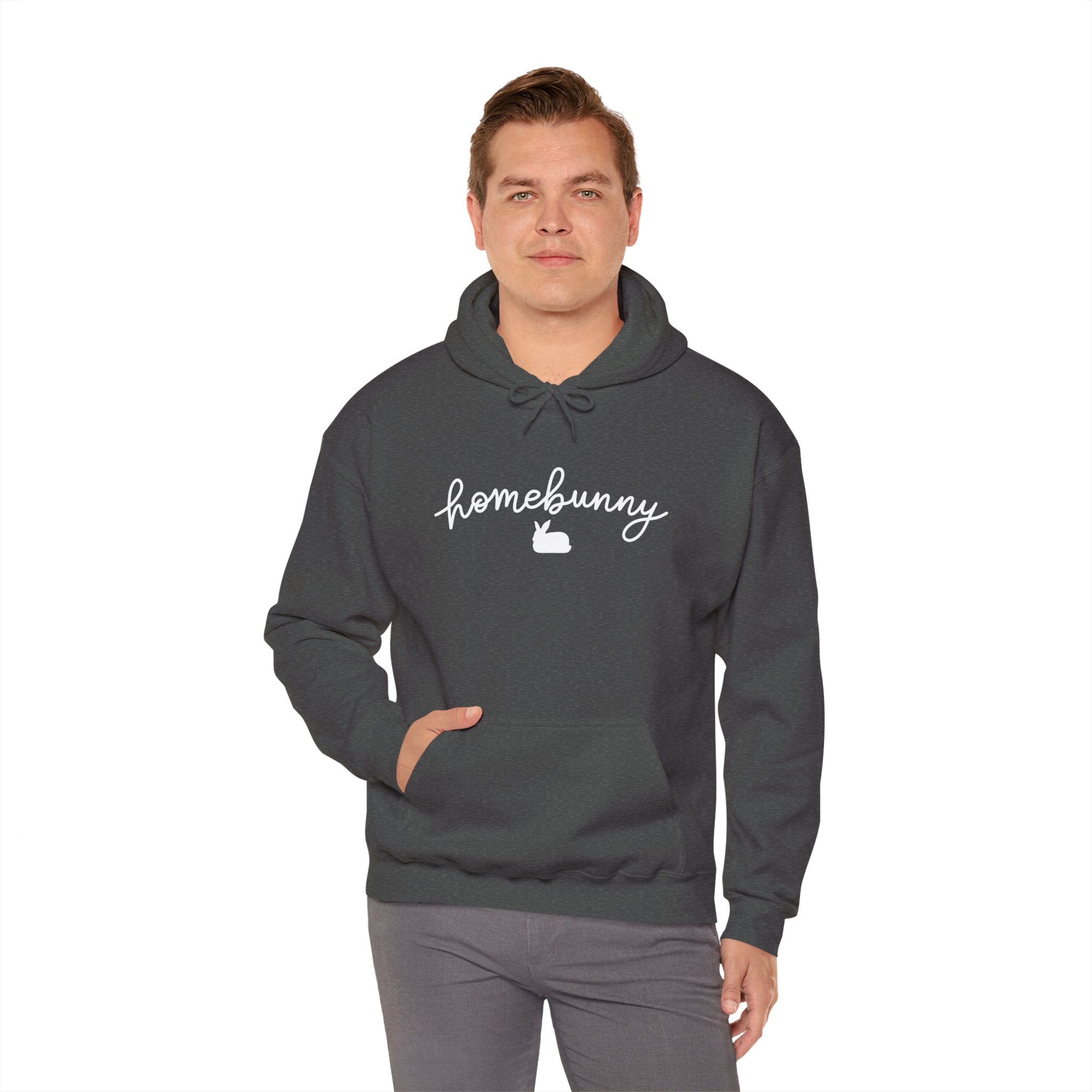 Man wearing a dark heather gray hoodie with 'homebunny' text on a white background