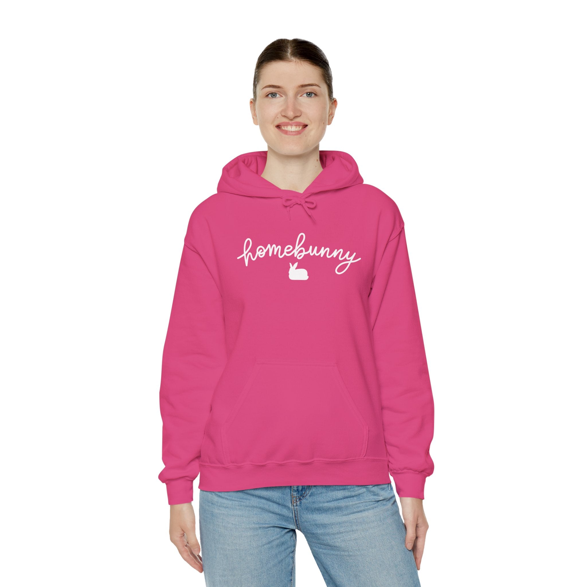 Person wearing a heliconia pink hoodie with 'homebunny' text on a white background