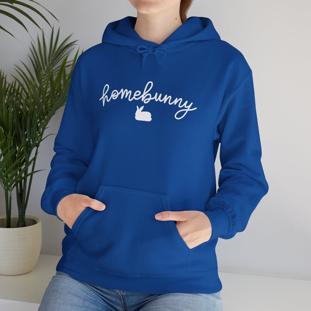 Person wearing a royal blue hoodie with 'homebunny' text and logo, standing indoors.