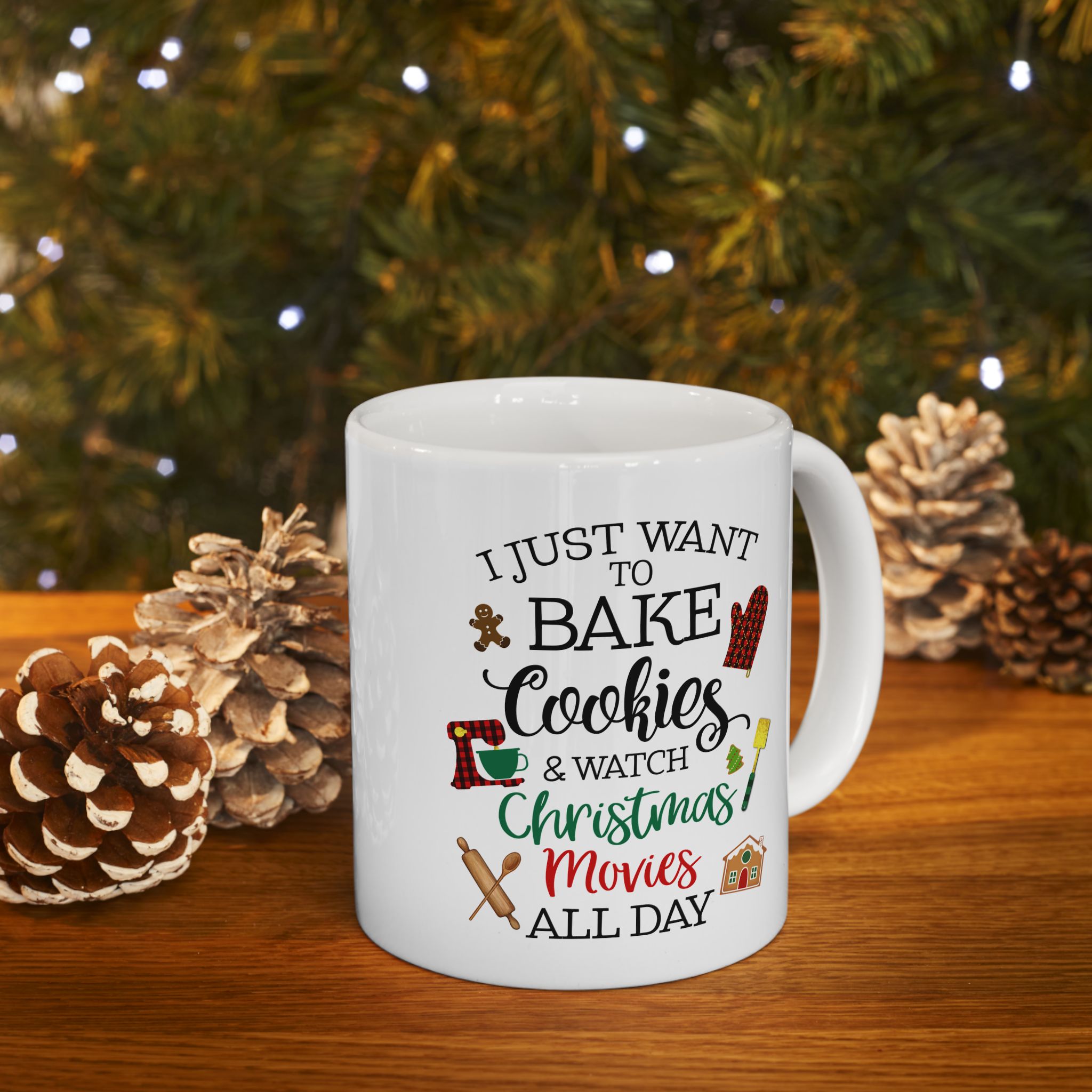 White ceramic mug with festive Christmas design and the phrase “I just want to bake cookies & watch Christmas movies all day,” featuring gingerbread, oven mitt, rolling pin, and holiday icons.
