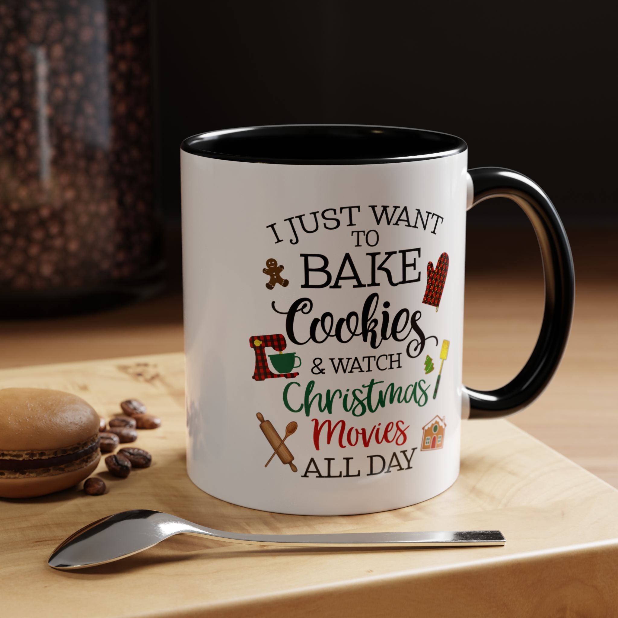 White mug with black interior and handle, featuring text and graphics on a wooden surface with cookies and coffee beans.
