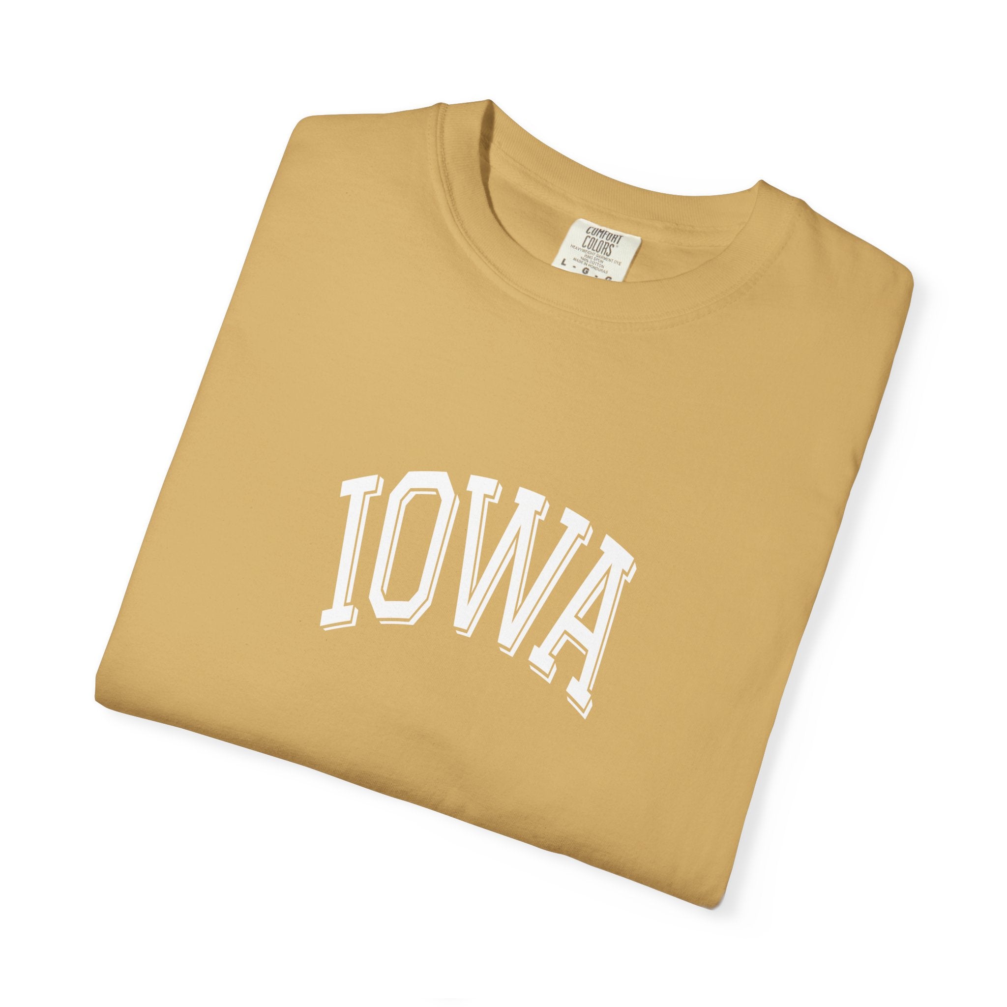 Folded Mustard Comfort Colors t-shirt with 'IOWA' print on a white background