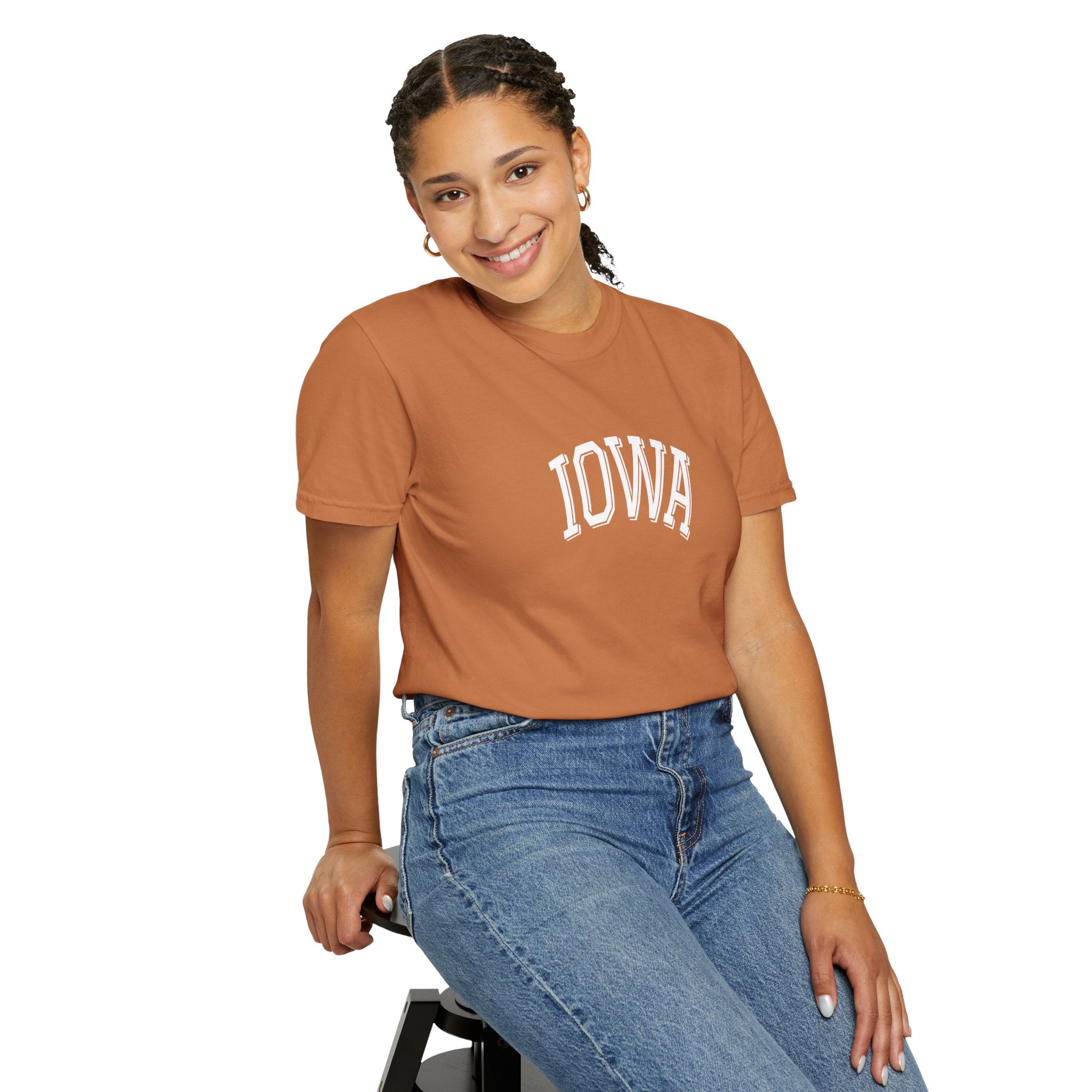 Person wearing a Comfort Colors Yam 'Iowa' t-shirt and blue jeans on a white background