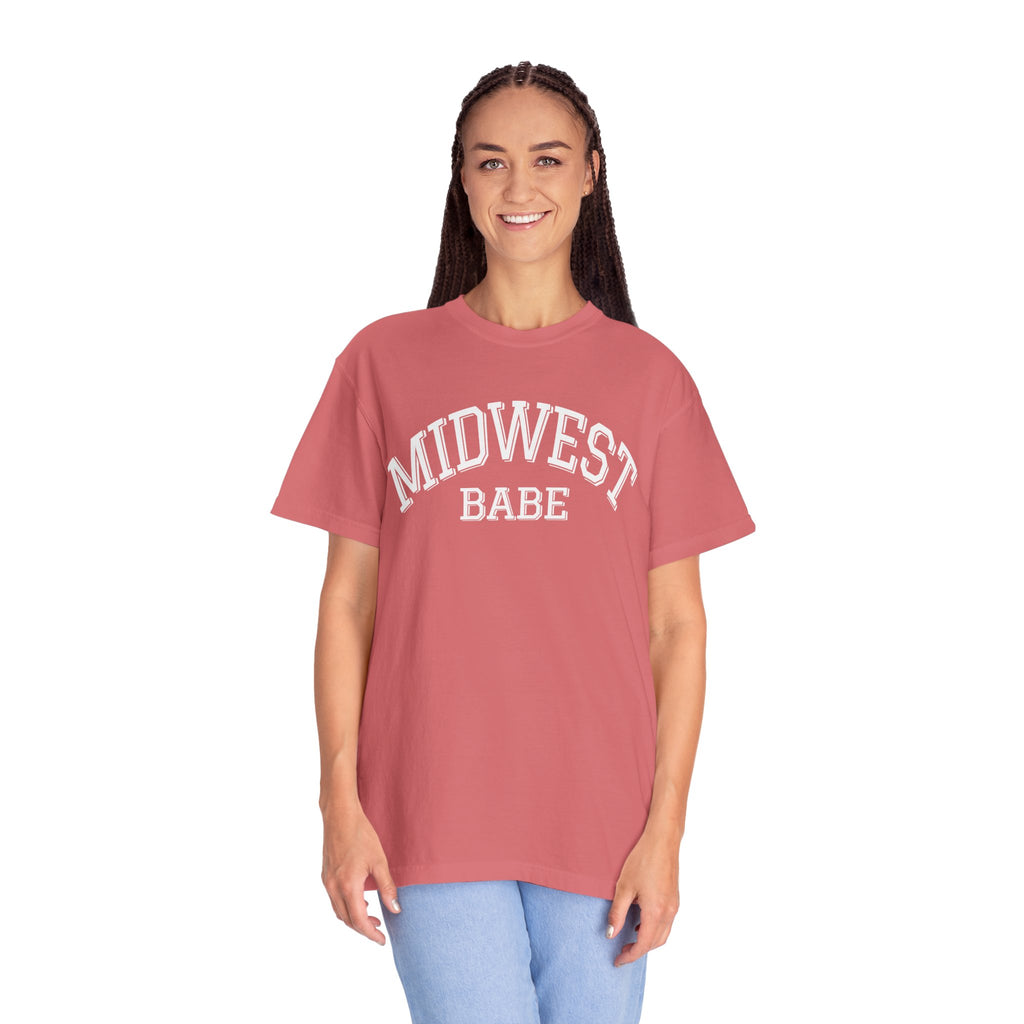 Person wearing a Comfort Colors t-shirt in watermelon with 'Midwest Babe' text on a white background