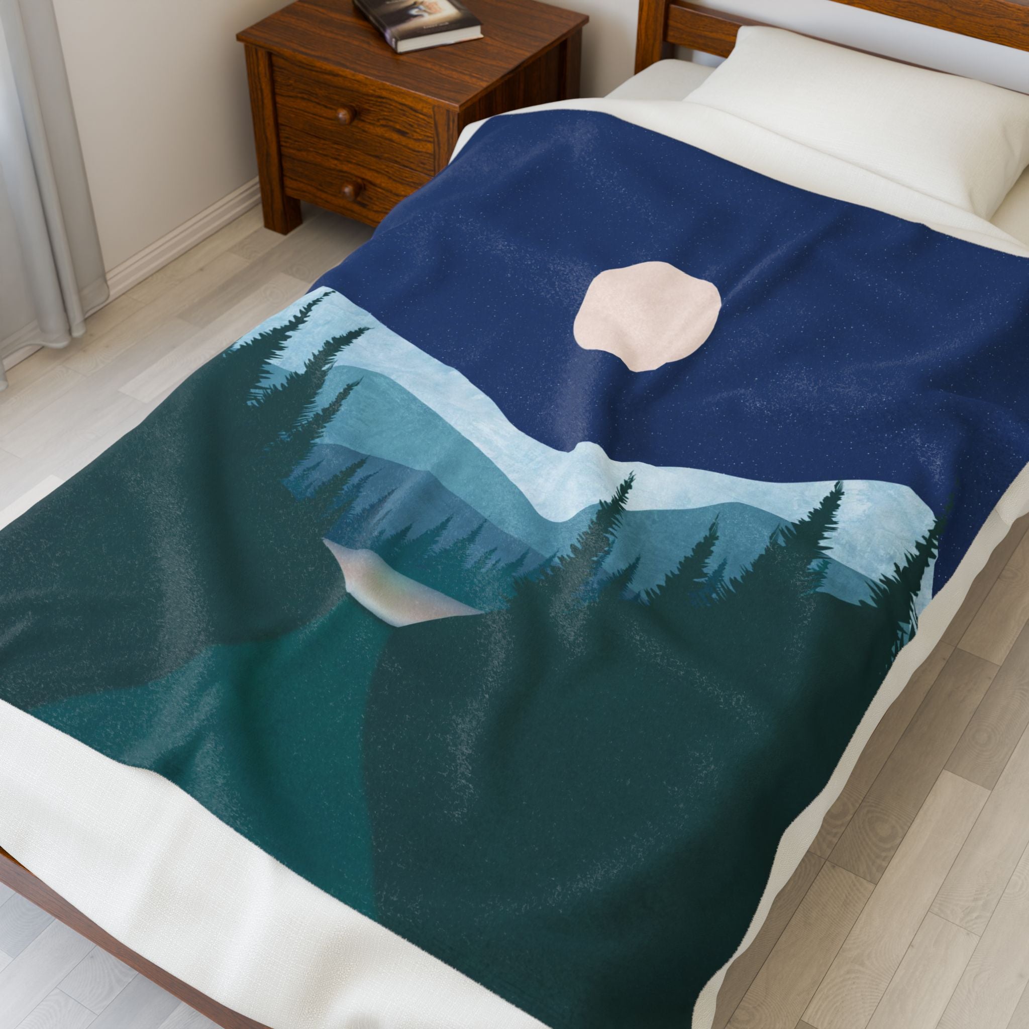 Blanket with mountain and moon design on a bed in a bedroom. night landscape blanket