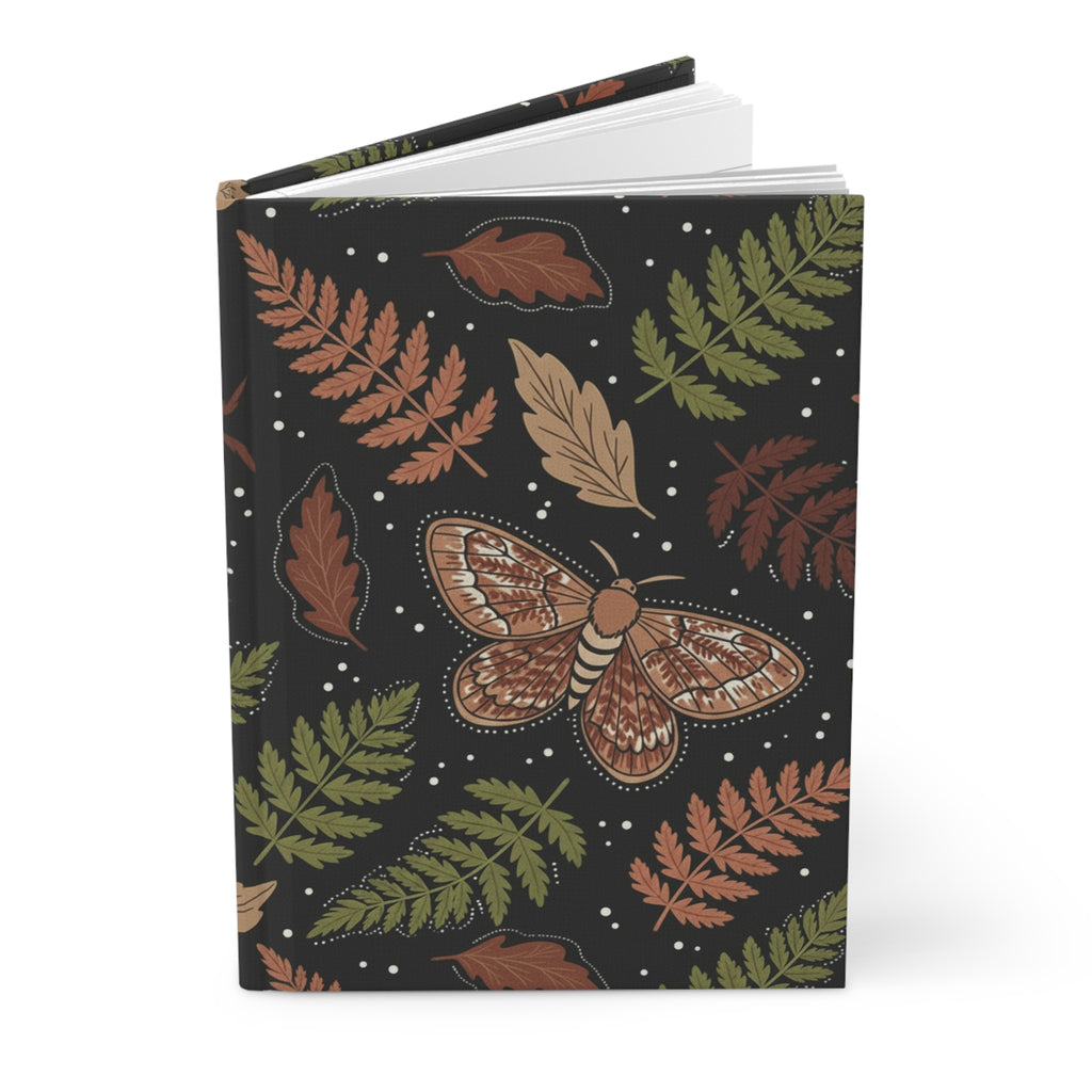 Journal with a moth and fern leaf design on a black background