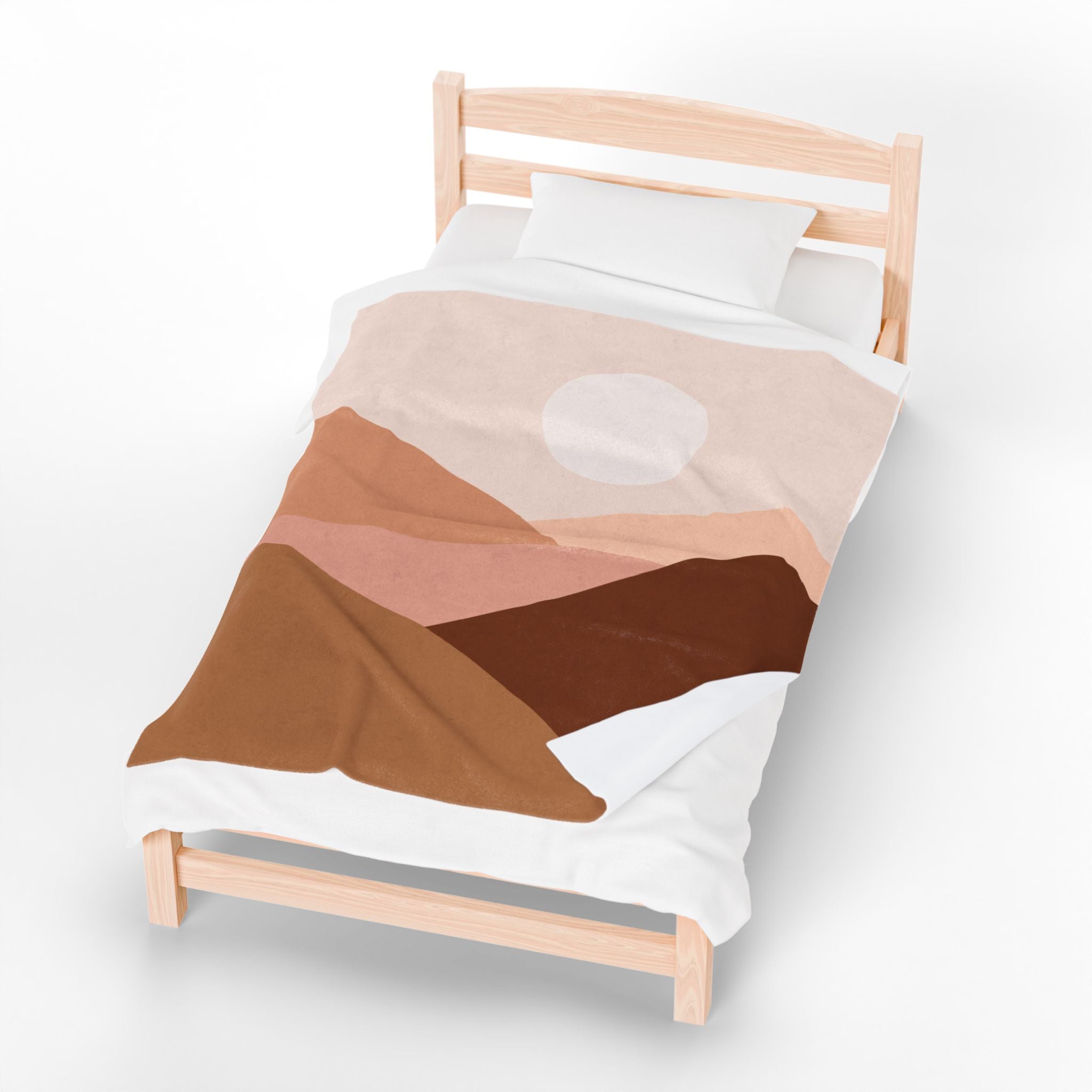 Bed with a abstract desert mountain scene throw blanket on a white background