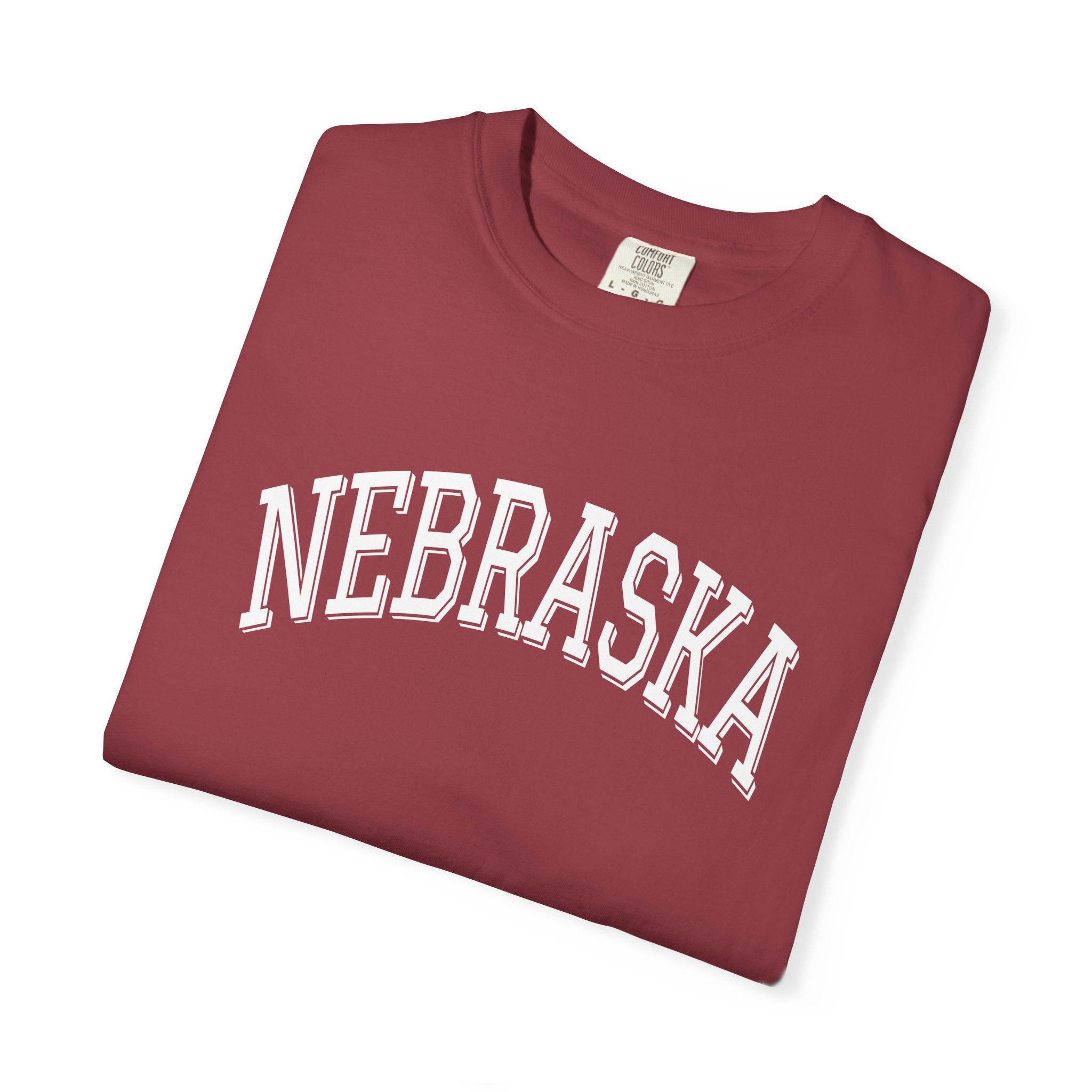 Folded Soft cotton tee with text 'Nebraska' in shade Chili