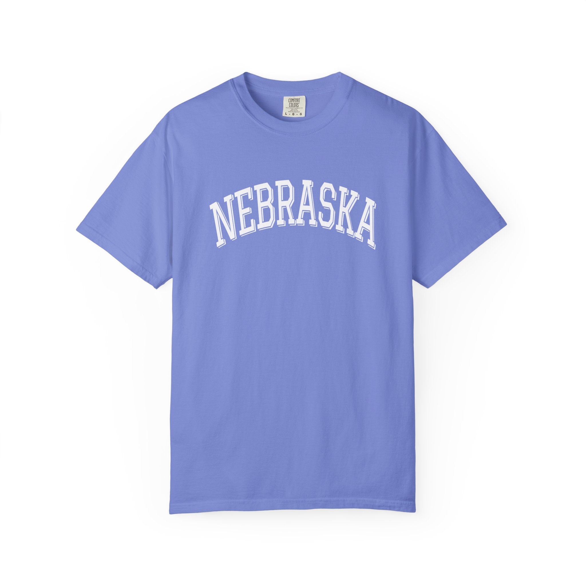 Comfort Colors Flo Blue t-shirt with 'NEBRASKA' printed on it against a white background