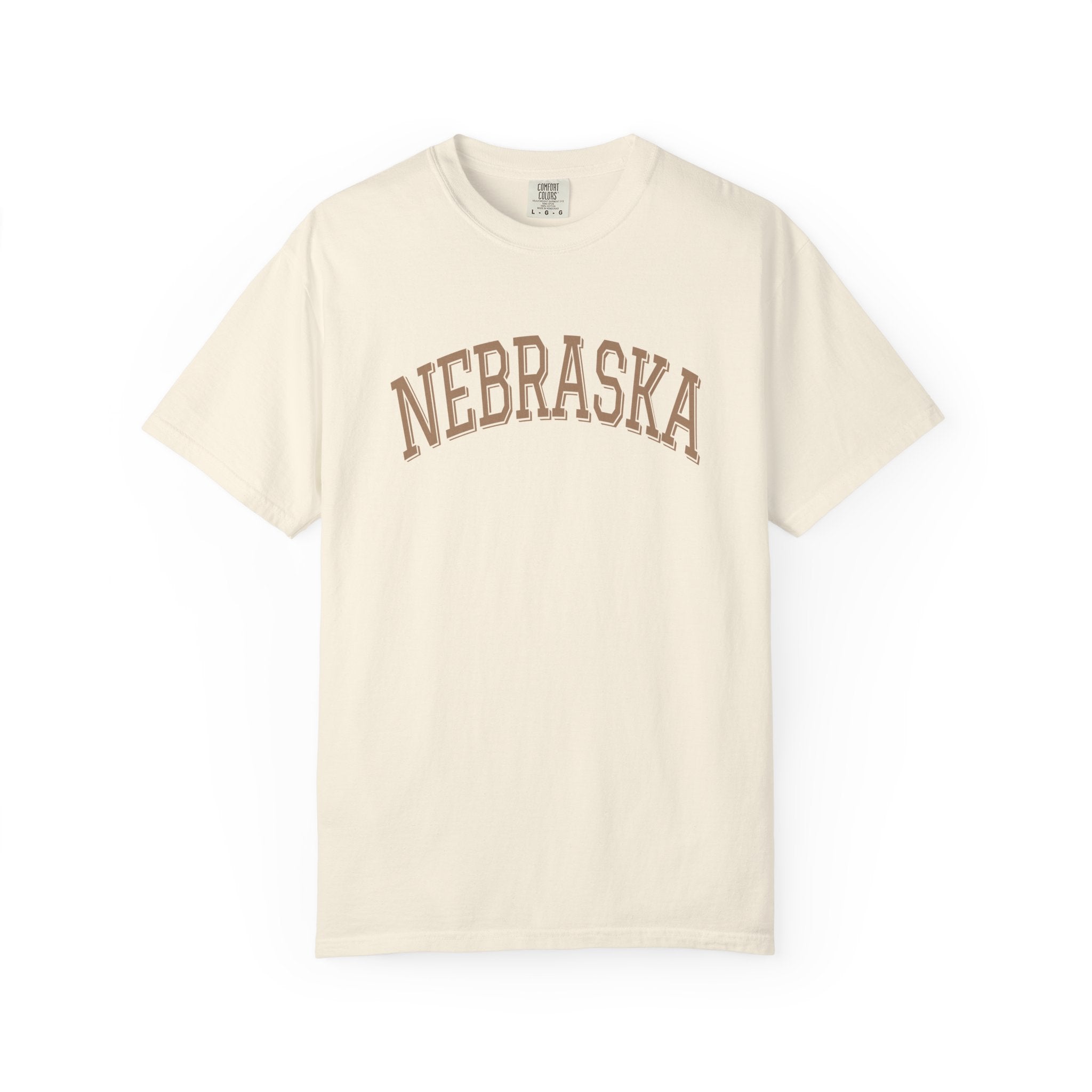 Ivory t-shirt with 'NEBRASKA' printed on it against a white background