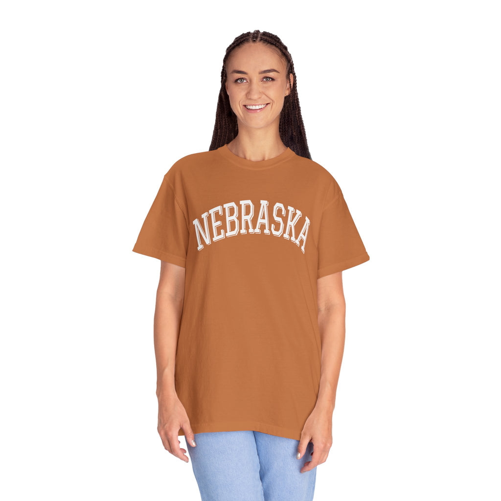 Girl wearing a Nebraska unisex t-shirt with classic state lettering