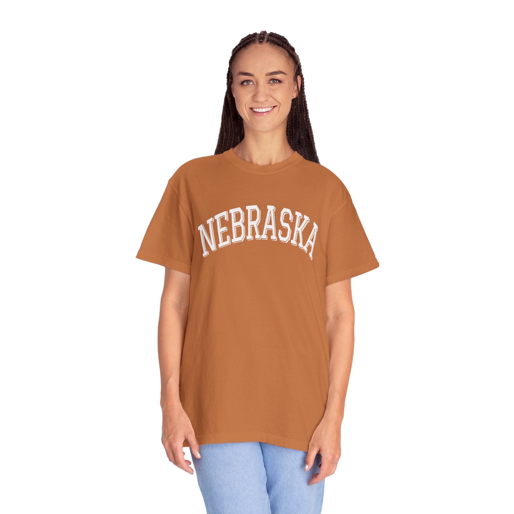 Girl wearing a Nebraska unisex t-shirt with classic state lettering