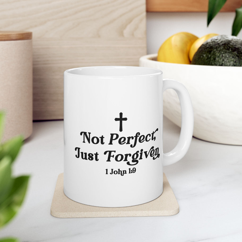 White 11 oz mug with Inspirational quote on coffee cup quote on a coaster, surrounded by home decor items.