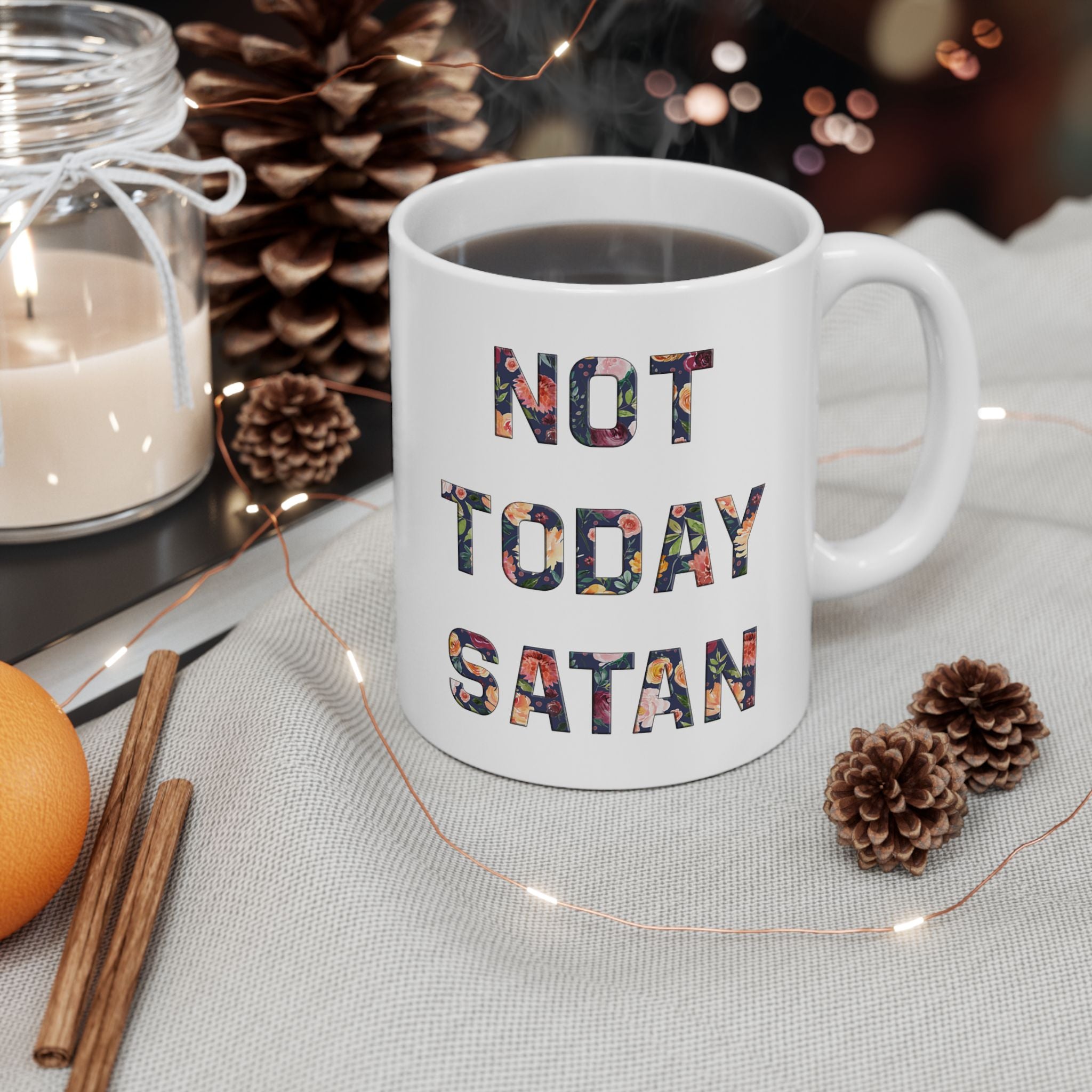 White mug with 'Not Today Satan' text on a table with decorative items