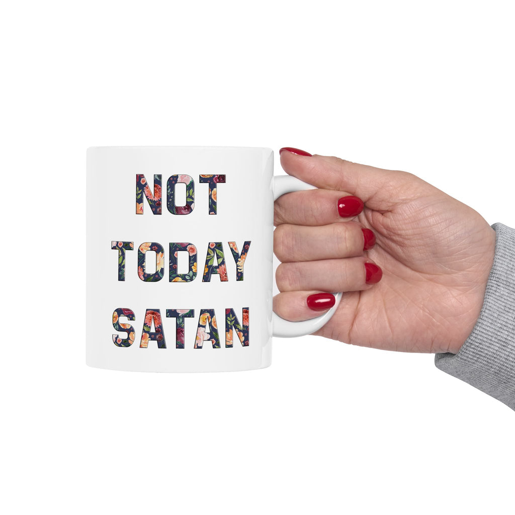 Mug with 'Not Today Satan' text held by a hand with red nail polish on a white background