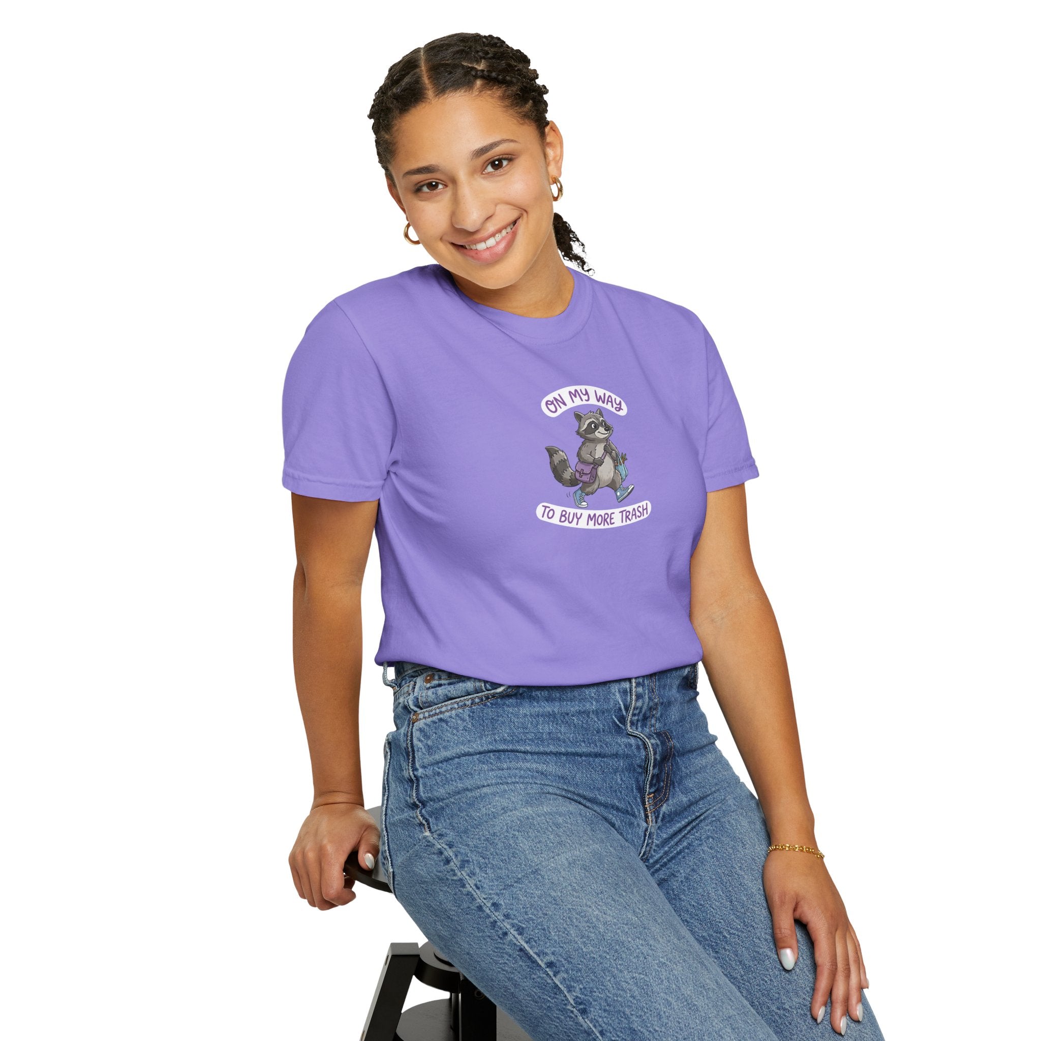 Person wearing a purple t-shirt with a graphic design on a white background