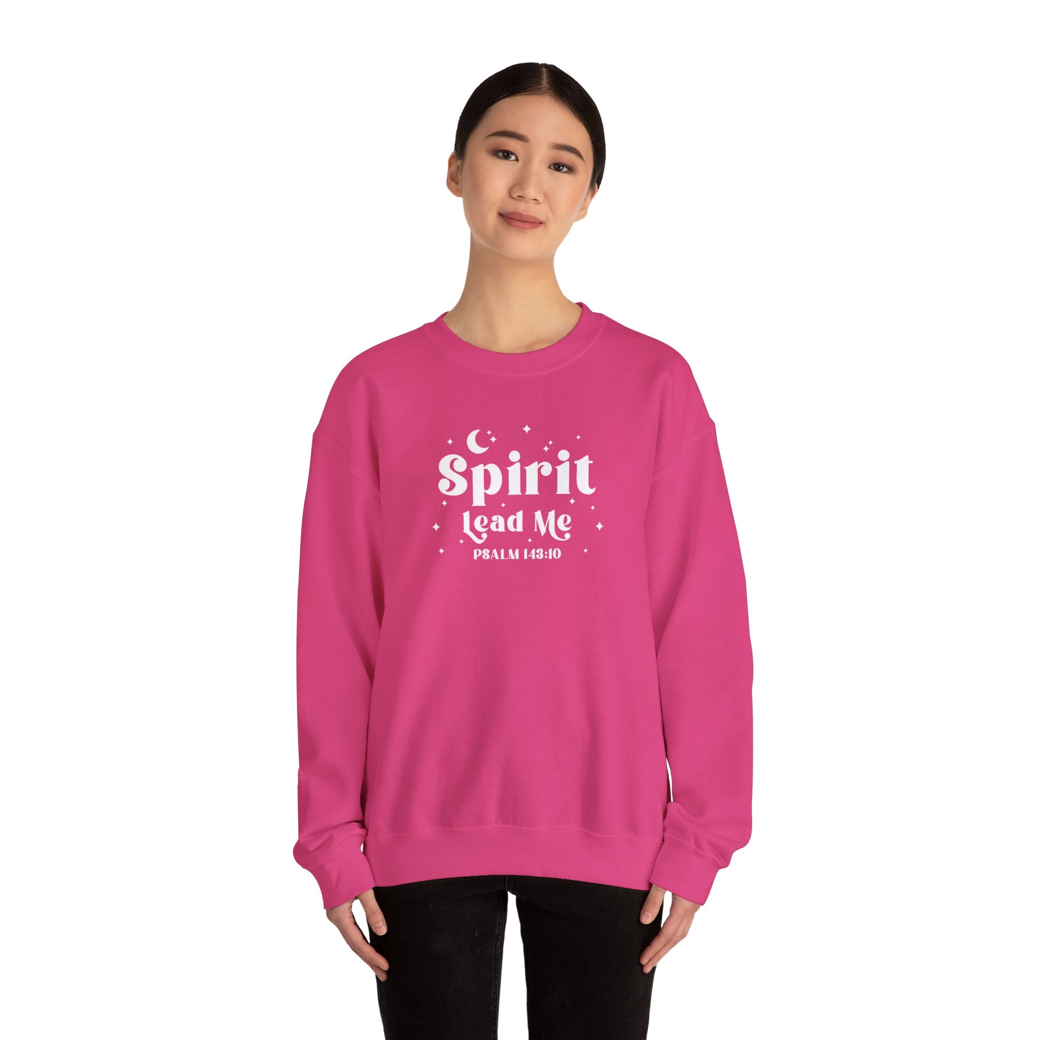 Person wearing a Heliconia pink sweatshirt with 'Spirit Lead Me' text on a white background