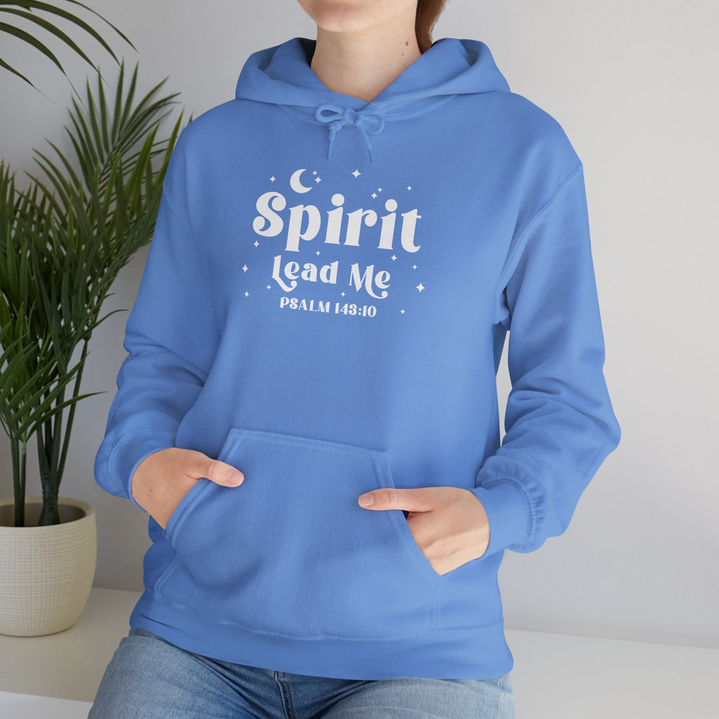 Person wearing a Carolina blue hoodie with 'Spirit Lead Me' text, standing indoors with a plant in the background. Stars and Moon design surrounding the text.