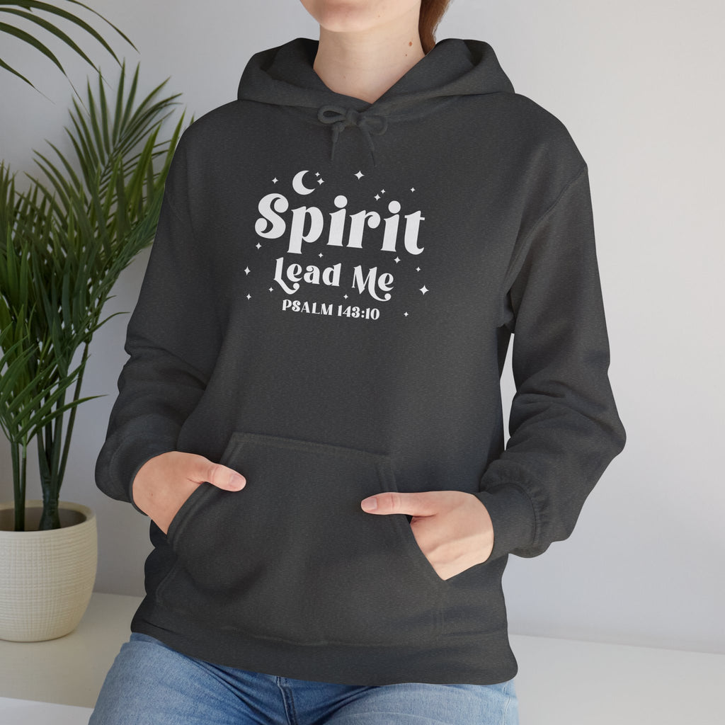 Person wearing a dark heather gray hoodie with 'Spirit Lead Me' text, standing indoors with a plant in the background.