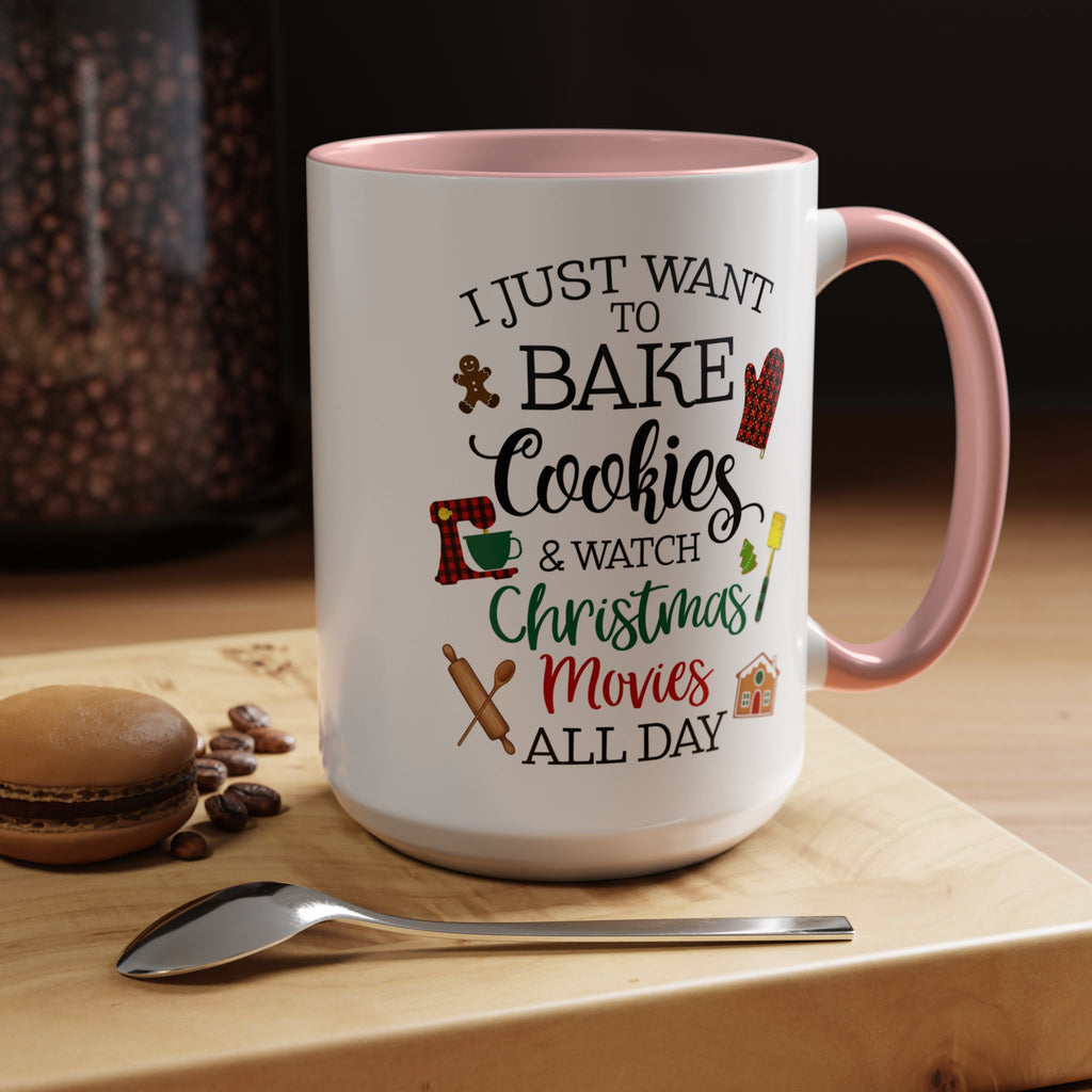 White 15 oz mug with pink interior and handle, featuring text and graphics on a wooden surface with cookies and a spoon.