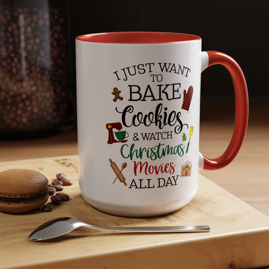 White 15 oz mug with red interior and handle, featuring Christmas-themed text and graphics, on a wooden surface with cookies and coffee beans.