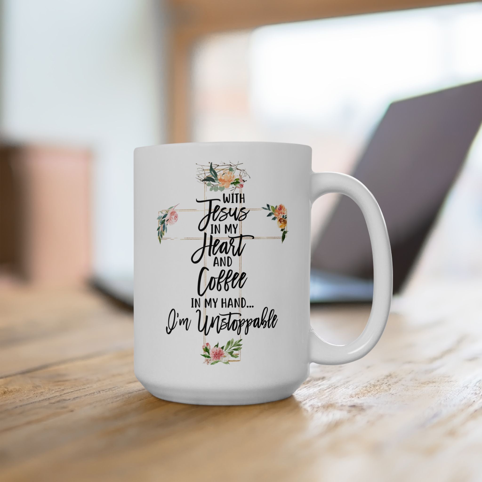 White ceramic Christian coffee mug with floral cross and quote “With Jesus in my heart and coffee in my hand, I’m unstoppable,” faith-based inspirational gift.